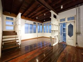 Spacious living room with wooden flooring and staircase