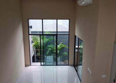 A spacious living room with large windows and modern design