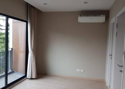 Bedroom with a large window and balcony