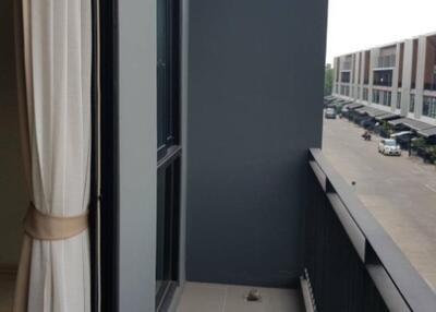 View of a narrow balcony extending from an apartment