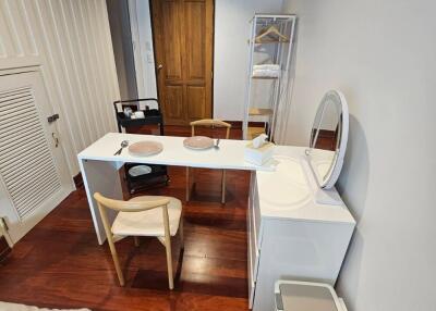 Compact bedroom with dining table and small vanity