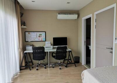 Modern home office with dual desks and chairs