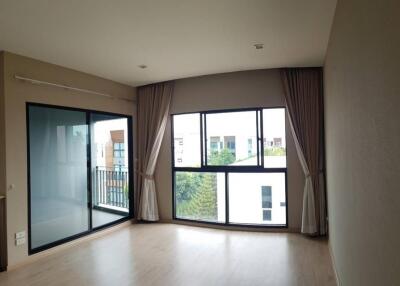 Bright and spacious living room with large windows and balcony access