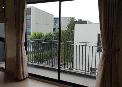 Living room with large window and balcony view