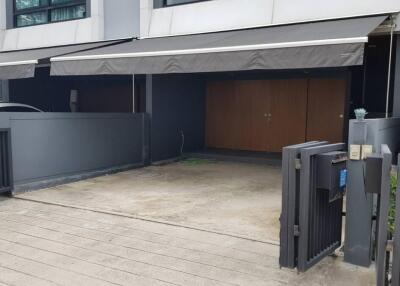 Modern garage with secure gate and awning