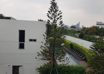 exterior view with poolside and greenery