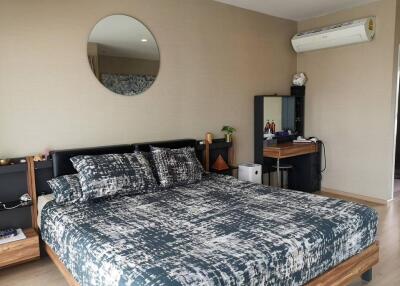 Modern bedroom with bed, mirror, and dresser