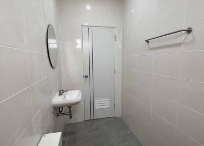 Clean and bright bathroom with a sink, toilet, and mirror.