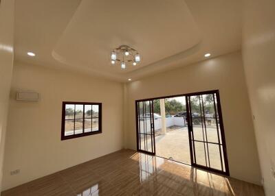 Spacious living room with large windows and sliding doors