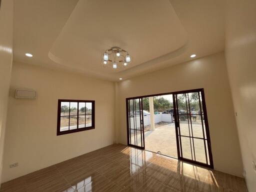 Spacious living room with large windows and sliding doors