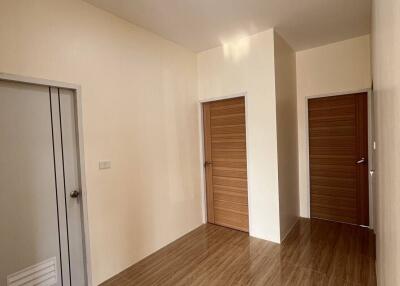 Clean and simple hallway with wooden doors and tiled floor