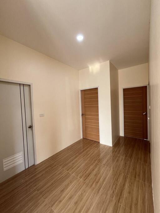 Clean and simple hallway with wooden doors and tiled floor