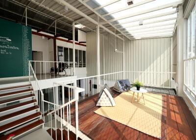 Modern industrial-style living room with skylights and loft area