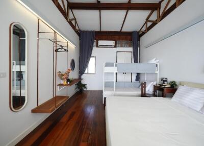 Modern bedroom with bunk bed and ample storage.