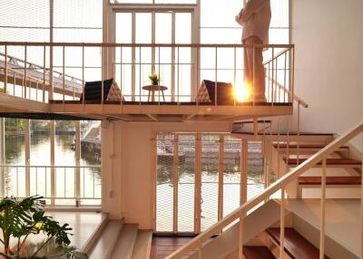 Modern living area with large windows and mezzanine