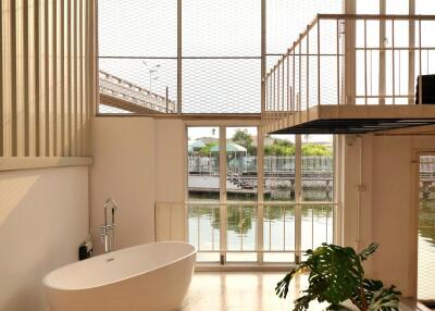 Spacious modern bathroom with a freestanding tub and large windows