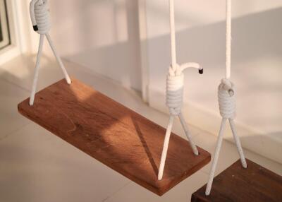 wooden swings hanging from balcony ceiling