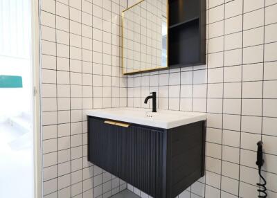 Modern bathroom with wall-mounted vanity and square tiles