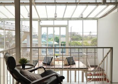 Indoor lounge area with a view of an outdoor deck