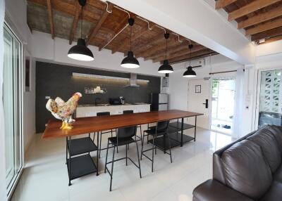 Modern kitchen with wooden dining table and black chairs