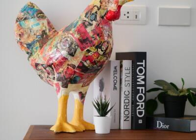 Decorative shelf with rooster statue and books