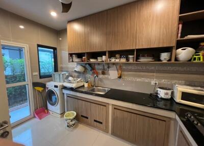 Modern kitchen with wooden cabinets and appliances