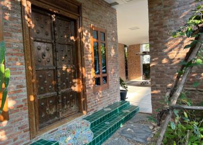 Front entrance with brick walls and wooden door