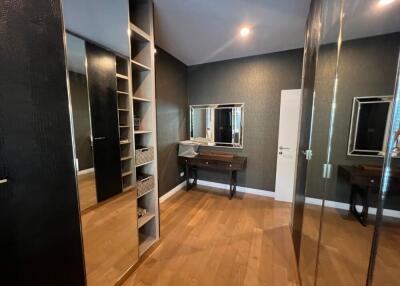 Modern bedroom with wooden floor and ample storage space