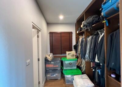 Walk-in closet with storage boxes and hanging clothes