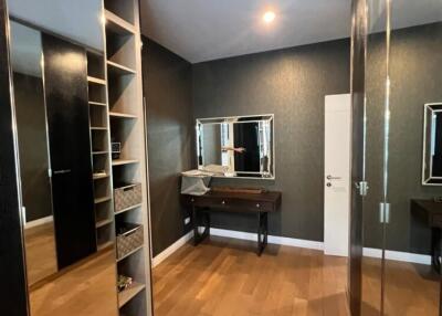 Walk-in closet with wooden flooring and vanity table