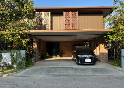 Modern two-story house with a covered garage and driveway