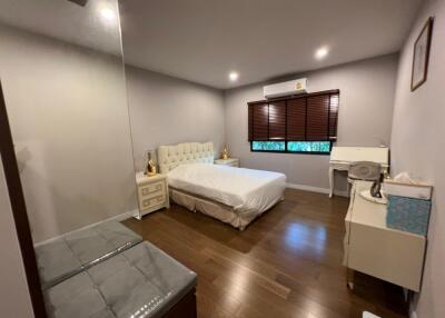 Modern bedroom with double bed, air conditioning, and wooden floor