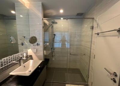 Modern bathroom with glass shower enclosure and vanity sink