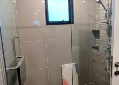 Modern bathroom with tiled shower and small window