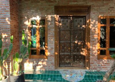 Exterior view of front door with brick wall