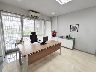 Modern office space with large window and desk