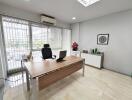 Modern office space with large window and desk