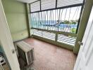 Spacious, covered balcony with tiled flooring and a view