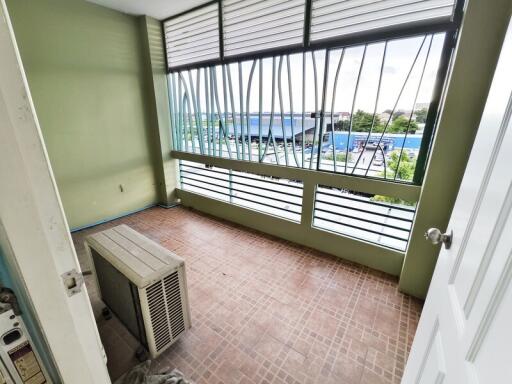 Spacious, covered balcony with tiled flooring and a view