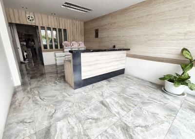 Reception area with a modern front desk and marble flooring