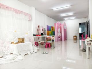 Bright room with white tiled floor and various decorations and furniture