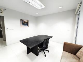 Well-lit office space with a desk and chair