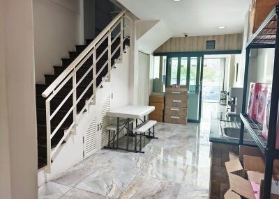 Bright living space with staircase and large windows