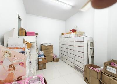 Storage room with stacked boxes and white shelving