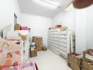 Storage room with stacked boxes and white shelving