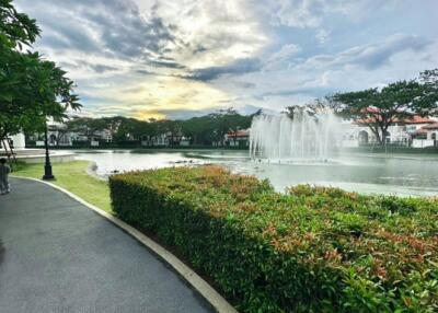 Beautiful outdoor path next to a pond with a fountain