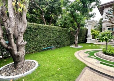 Lush garden with trees and well-maintained greenery