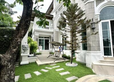 View of the exterior of a house with landscaped garden and a swing