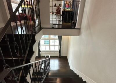 Modern staircase with dark wood steps and wrought iron railing