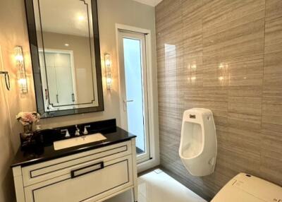 Modern bathroom with vanity, mirror, and fixtures